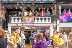 Crowds of people walking past Cinderbox coffee on bridge street for chester pride