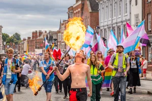 somebody blowing fire as part of chester pride 2024 on lower bridge street