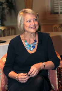 A photo of a woman sitting down looking to the left