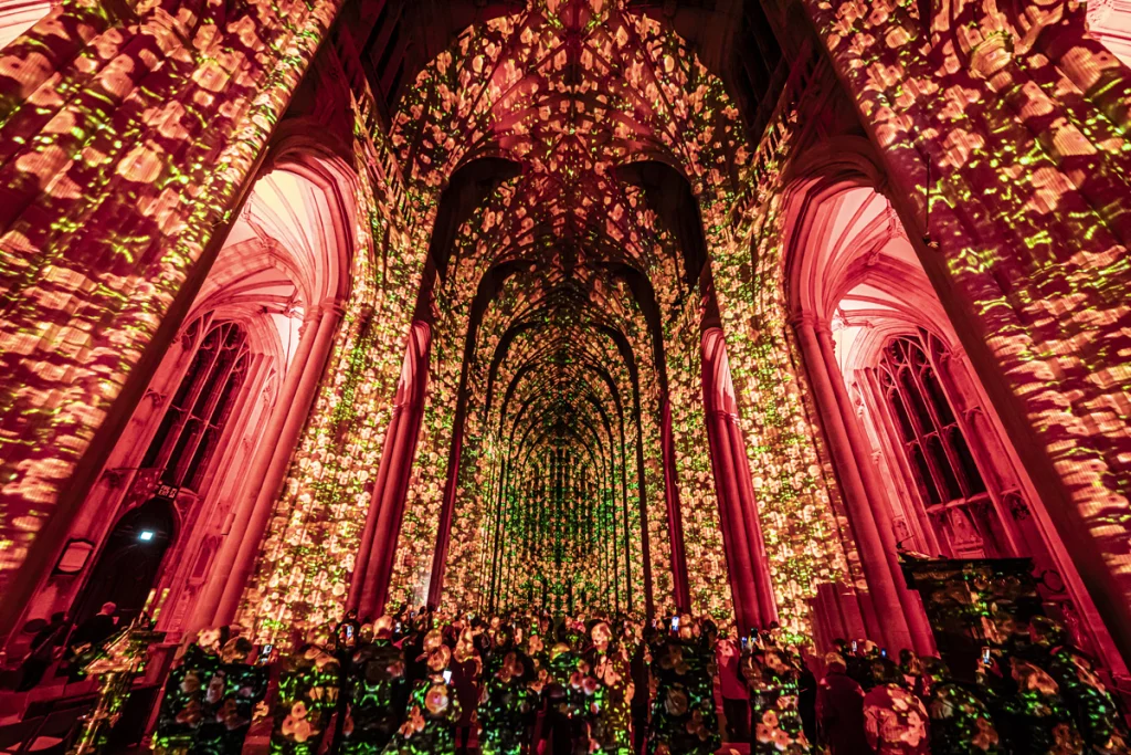 A Cathedral light up with images of poppys