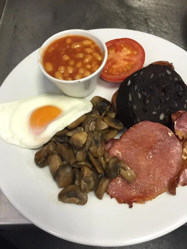 A full English breakfast on a white plate