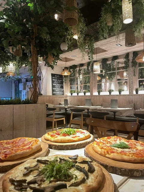 Different types of pizza on a table in a Mediterranean restaurant