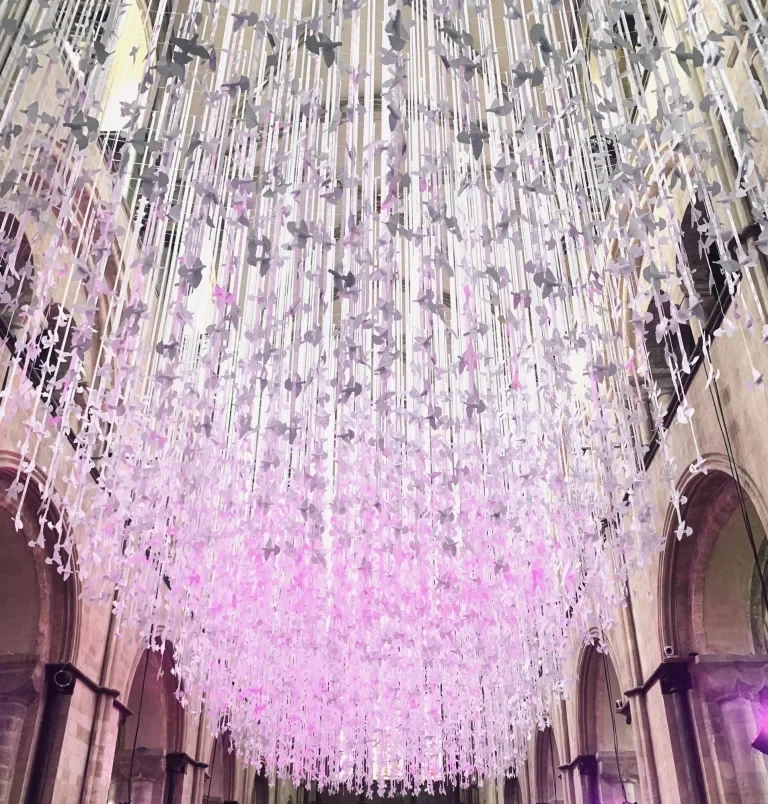 100's of paper doves in an art installation hanging from the cathedral