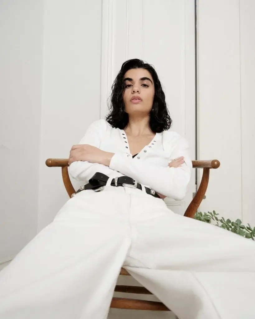 a girl in all white denim with a black belt