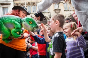 young boy stroking baby dinosaur