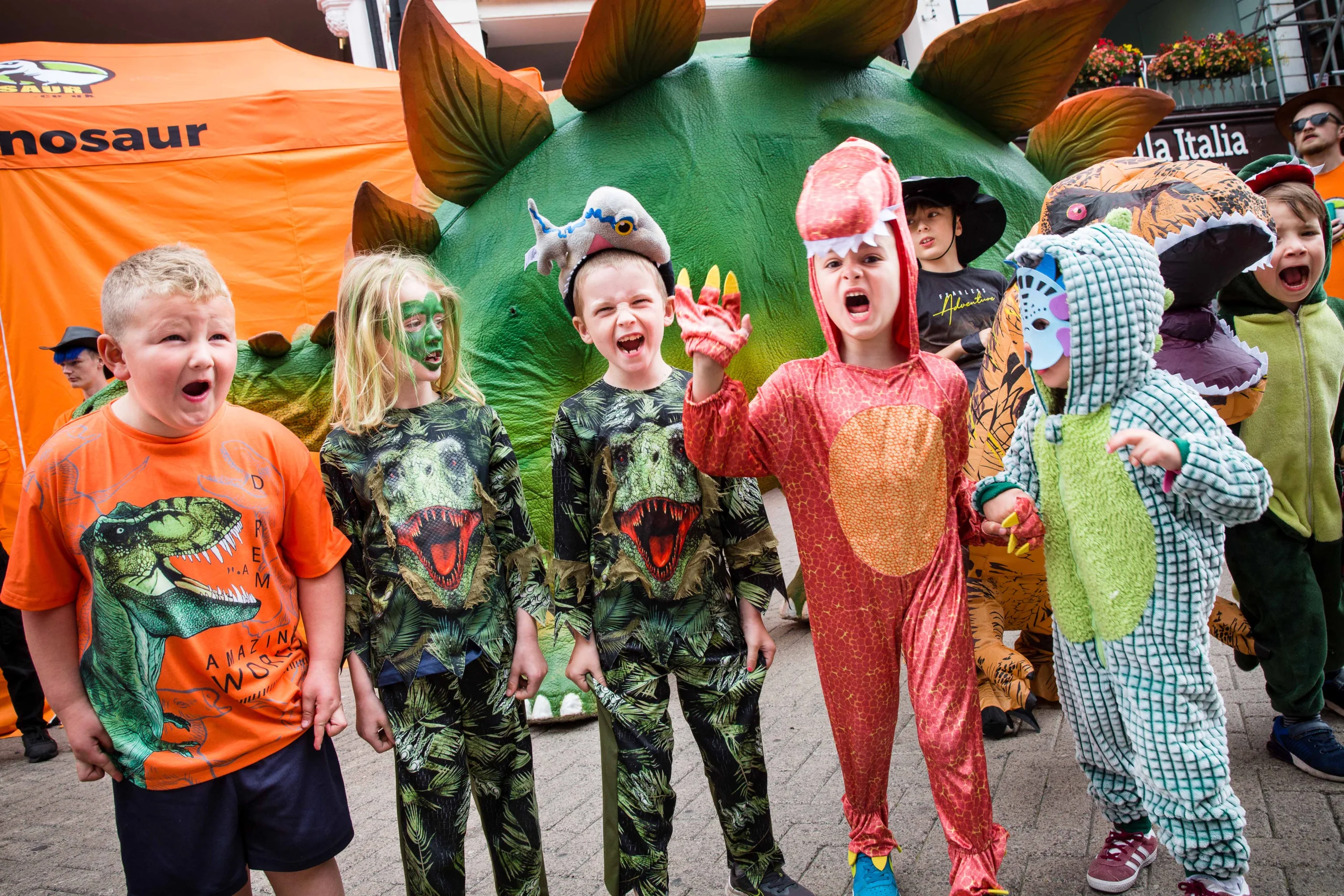 a group of children dressed up in dinosaur costumes