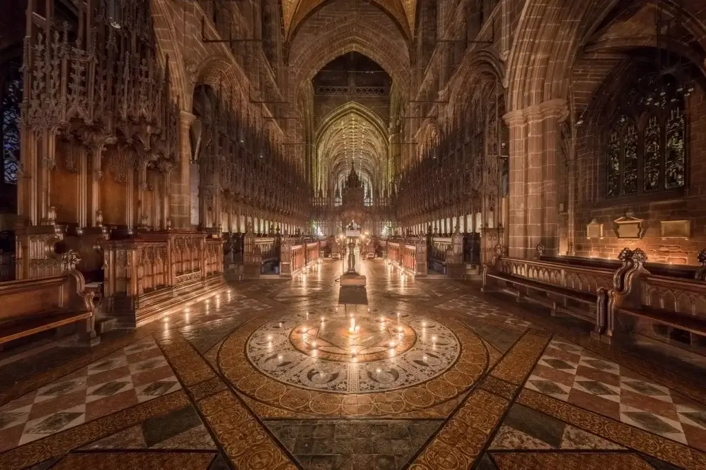 An image inside Chester Cathedral with candles lighting the interior